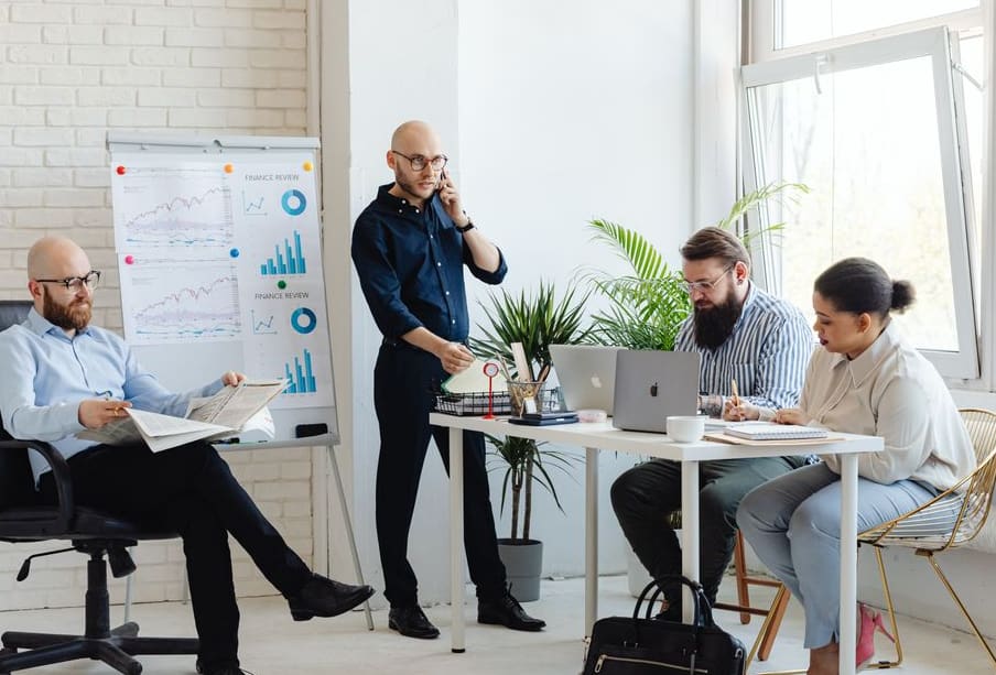 Business team reviewing lead generation results on a laptop in an office